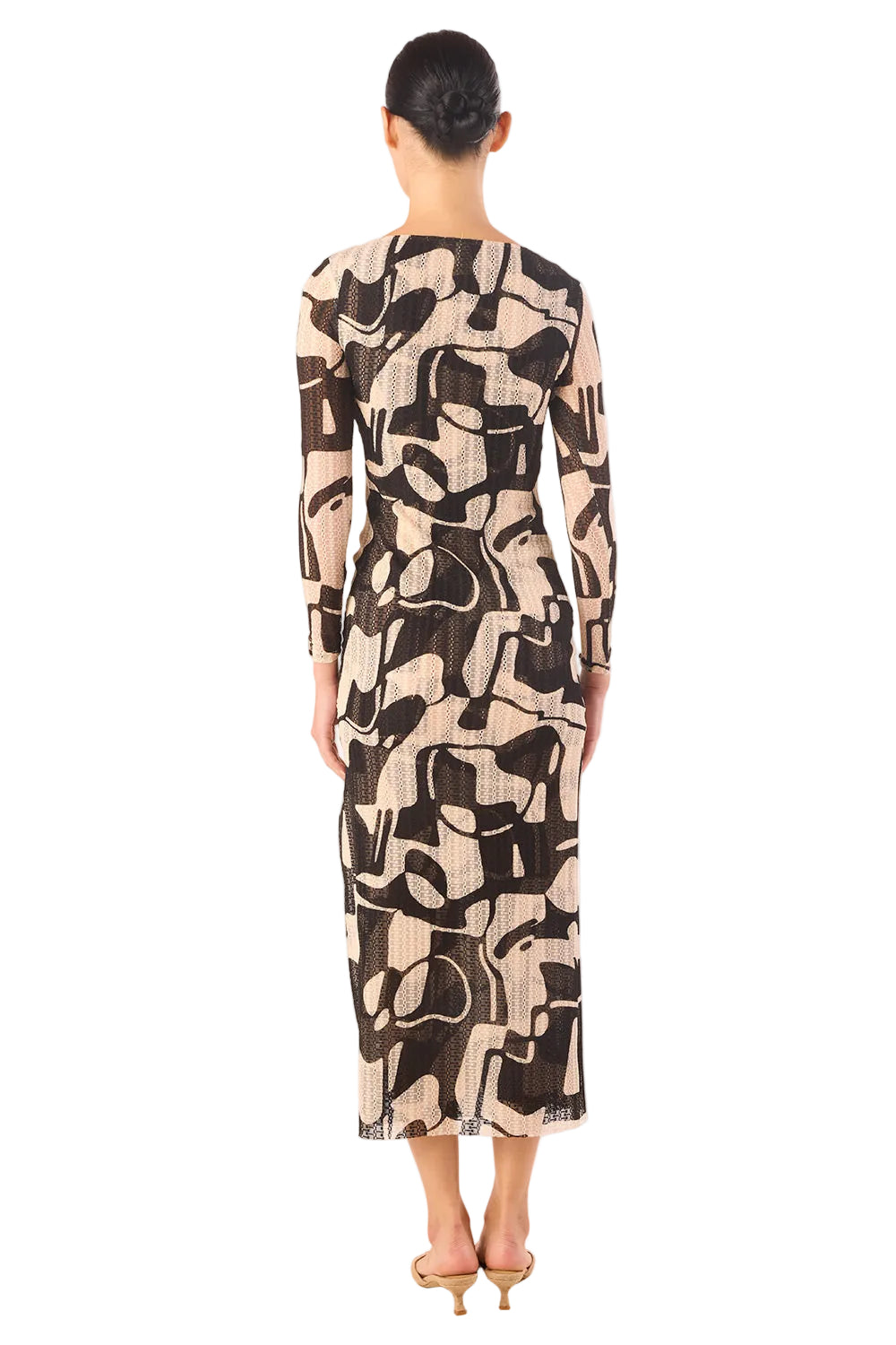 Model wearing a long, patterned dress on a white background
