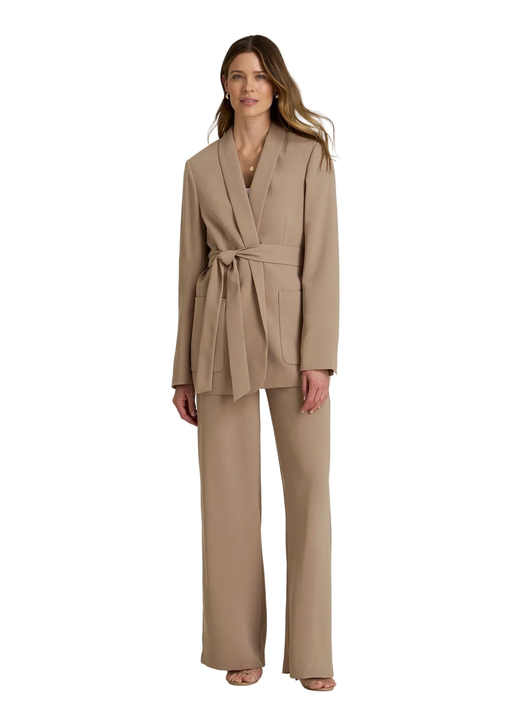 Woman wearing a beige suit on a plain background
