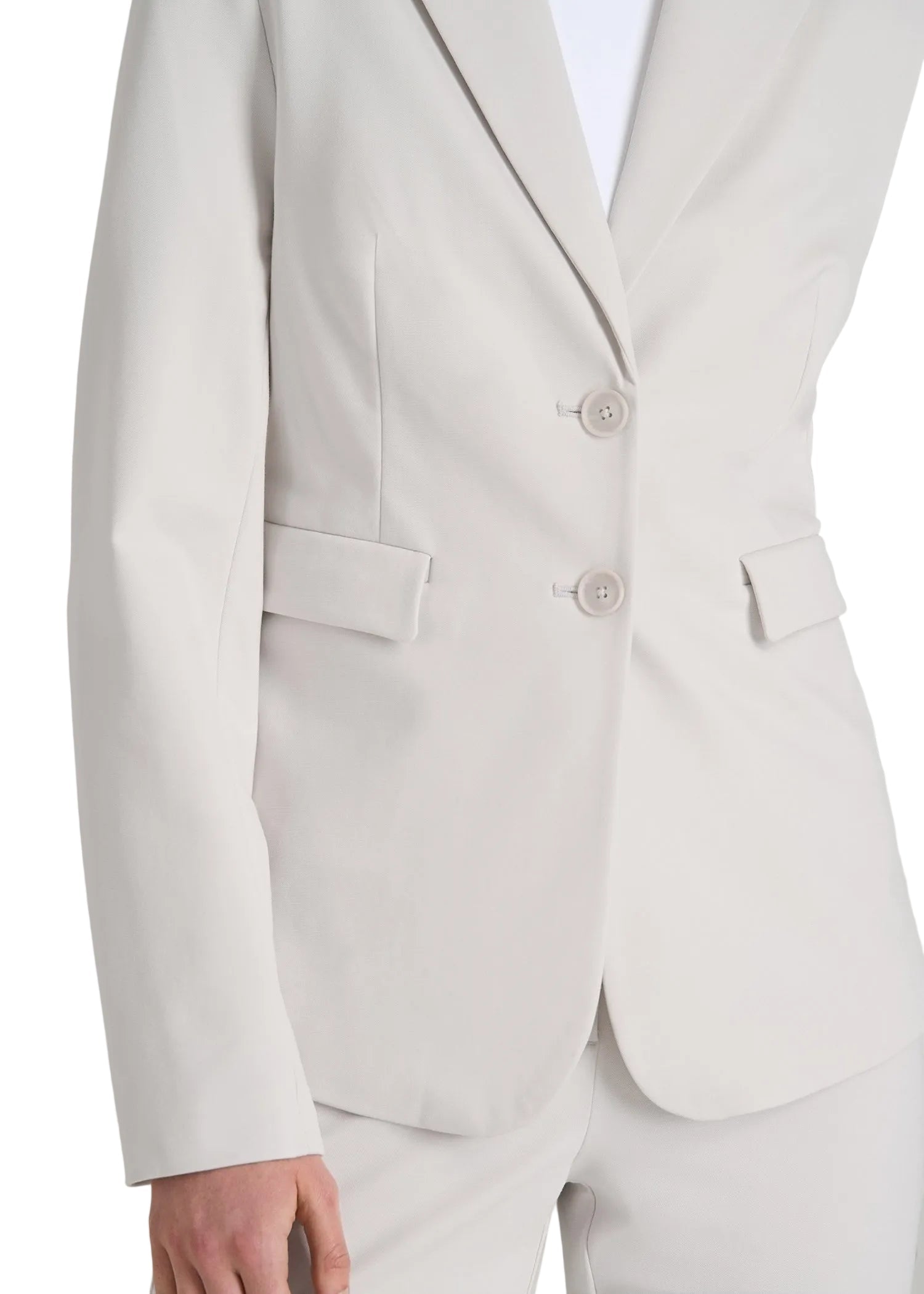 Close-up of a light gray suit jacket with buttons and a pocket on a plain background