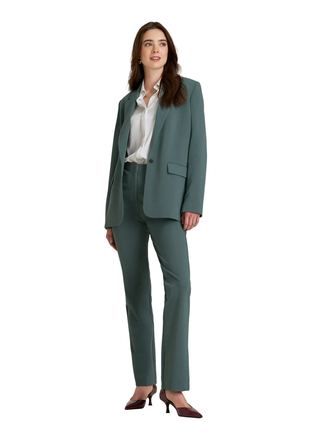Woman wearing a green suit on a white background