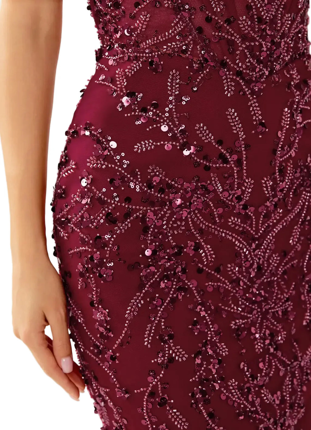 Close-up of a burgundy evening gown with intricate beadwork on a neutral background
