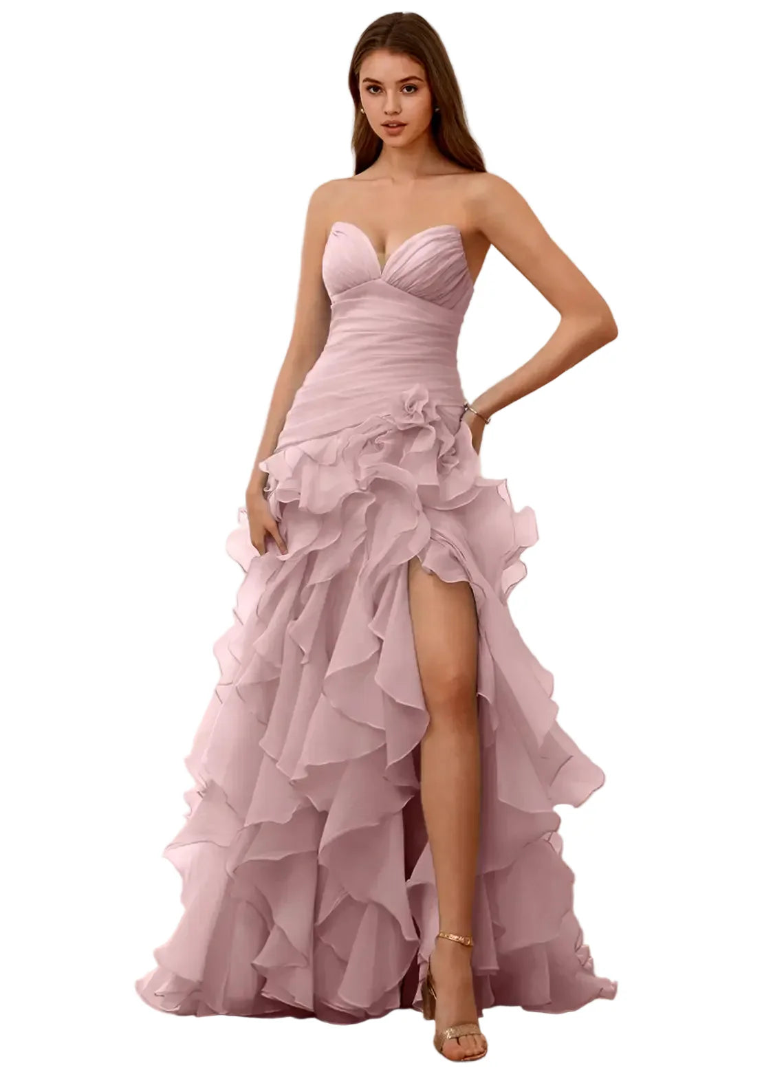 Woman wearing a pink strapless gown with ruffled layers in a room with wooden floor and white walls.