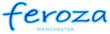 The logo for Feroza Manchester, featuring the word 'feroza' in a stylized blue cursive font with a light blue outline, and 'MANCHESTER' in smaller, plain light blue text underneath, all centered on a solid white background.