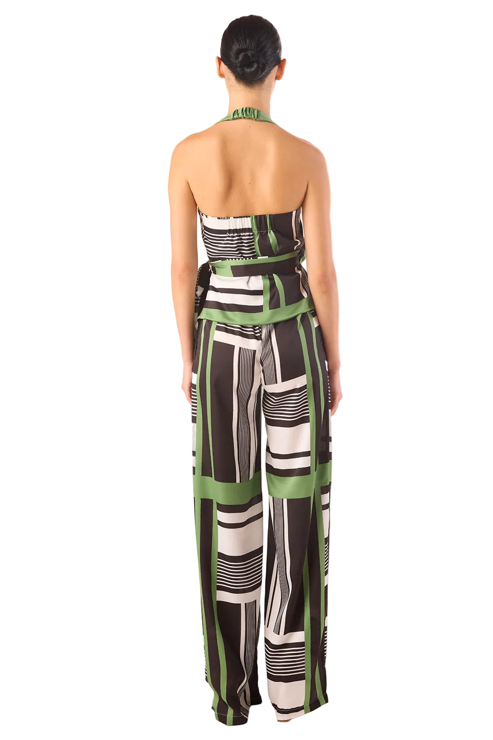 Woman wearing a strapless jumpsuit with geometric pattern on a white background