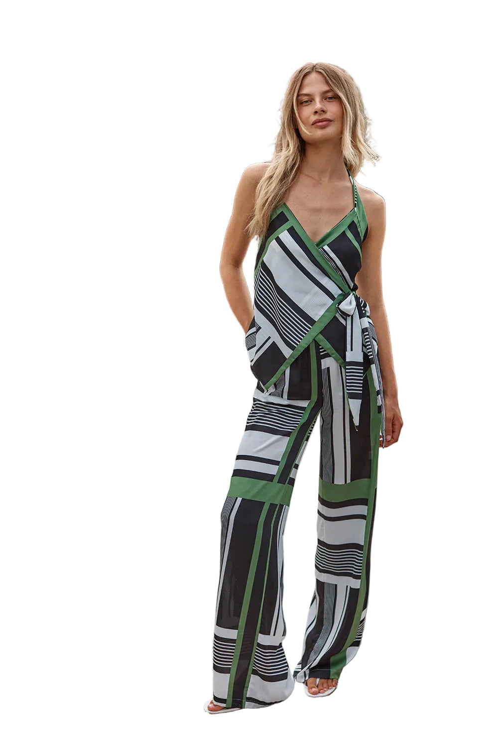 Woman wearing a patterned jumpsuit standing outdoors with trees in the background