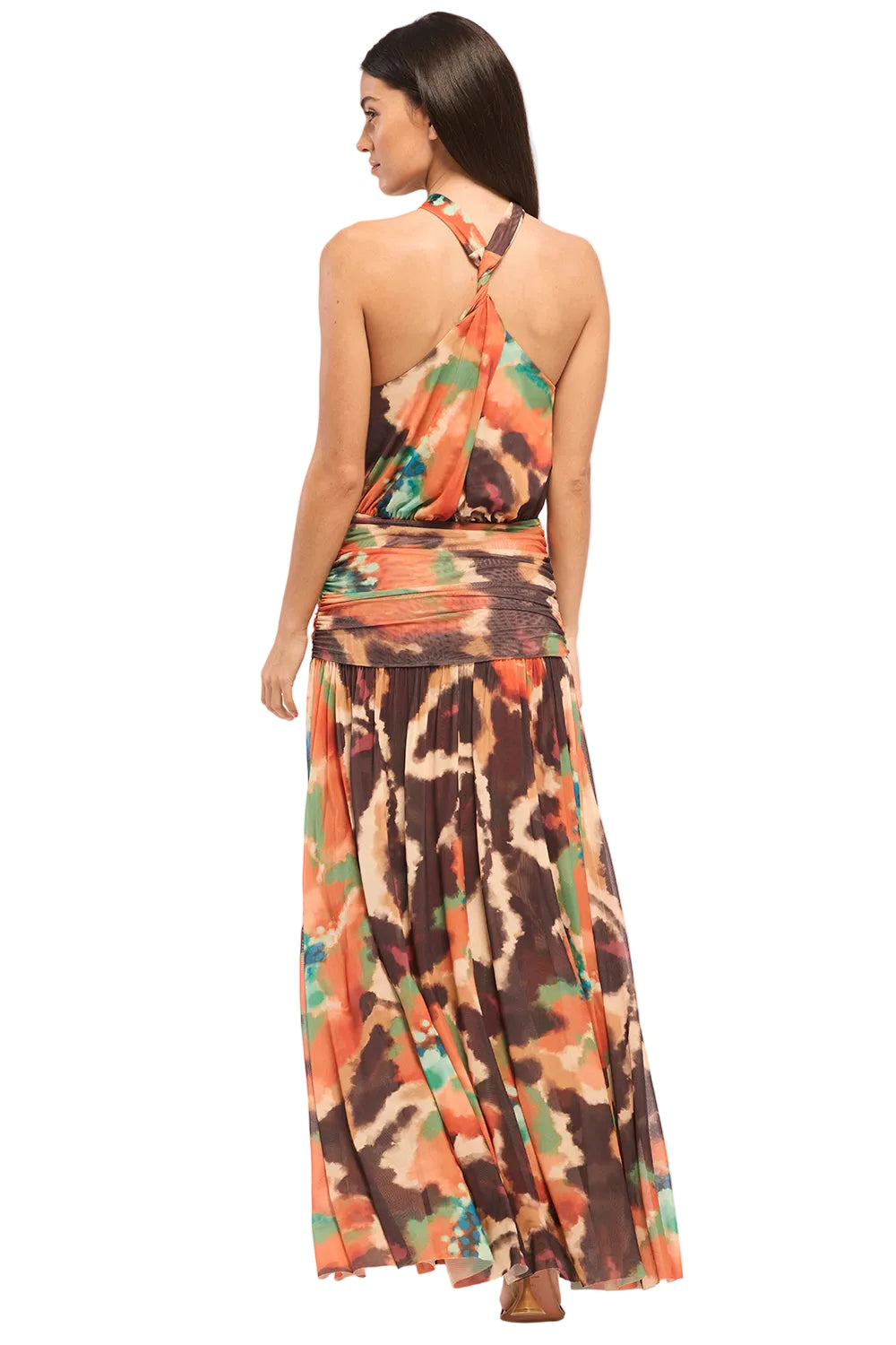 Woman wearing a colorful halter neck dress on a white background