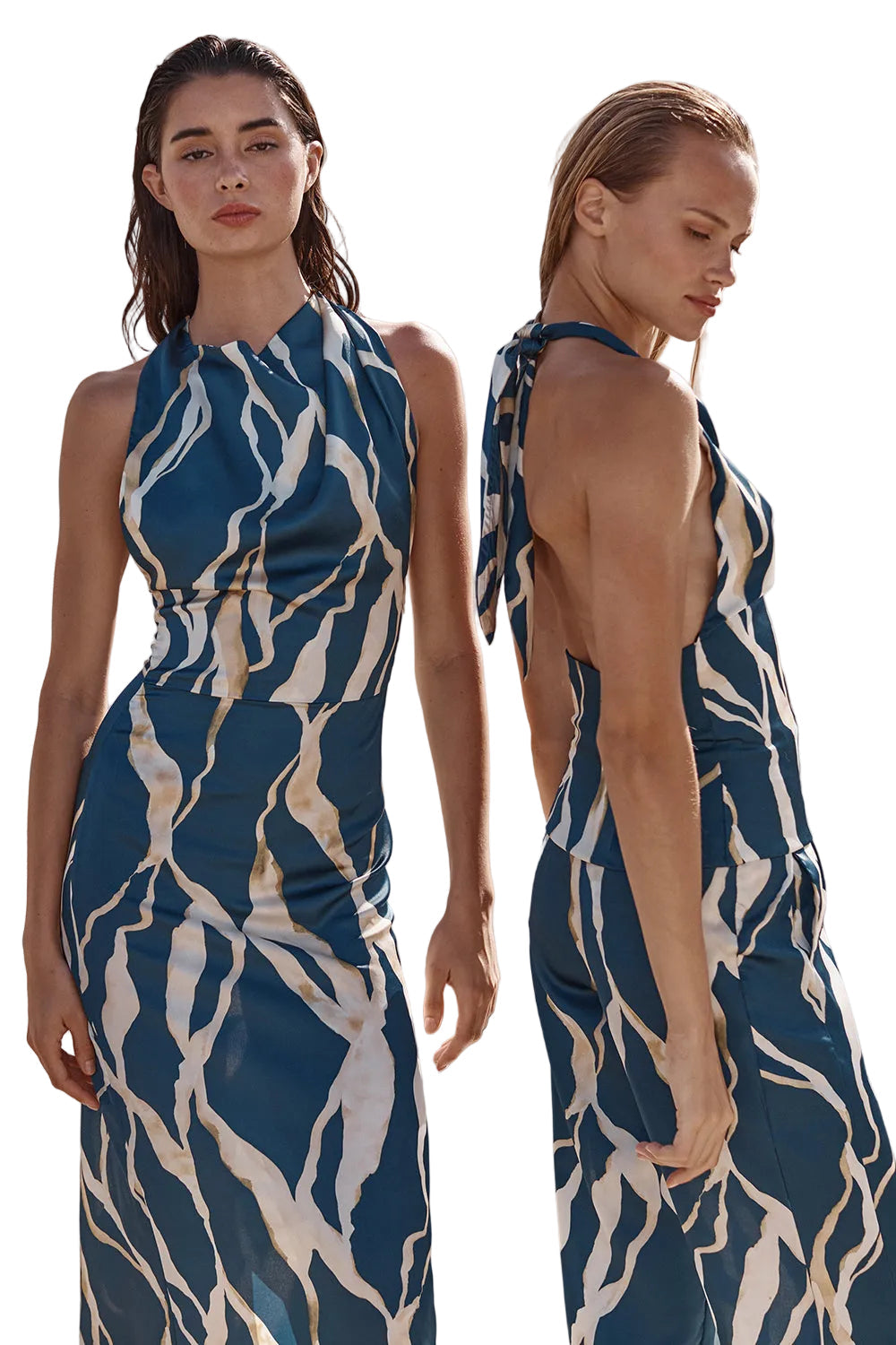 Woman wearing a blue and white patterned dress standing against a neutral background